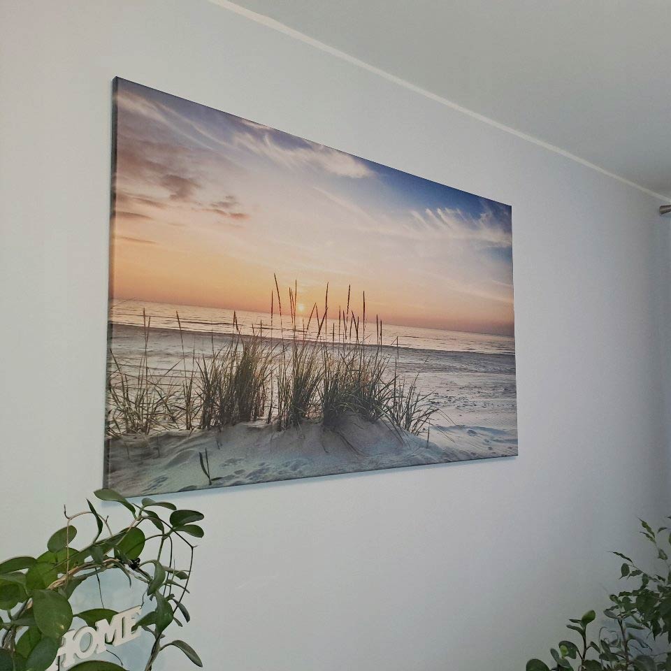 Obraz na płótnie przedstawiający piaszczystą plażę o zachodzie słońca
